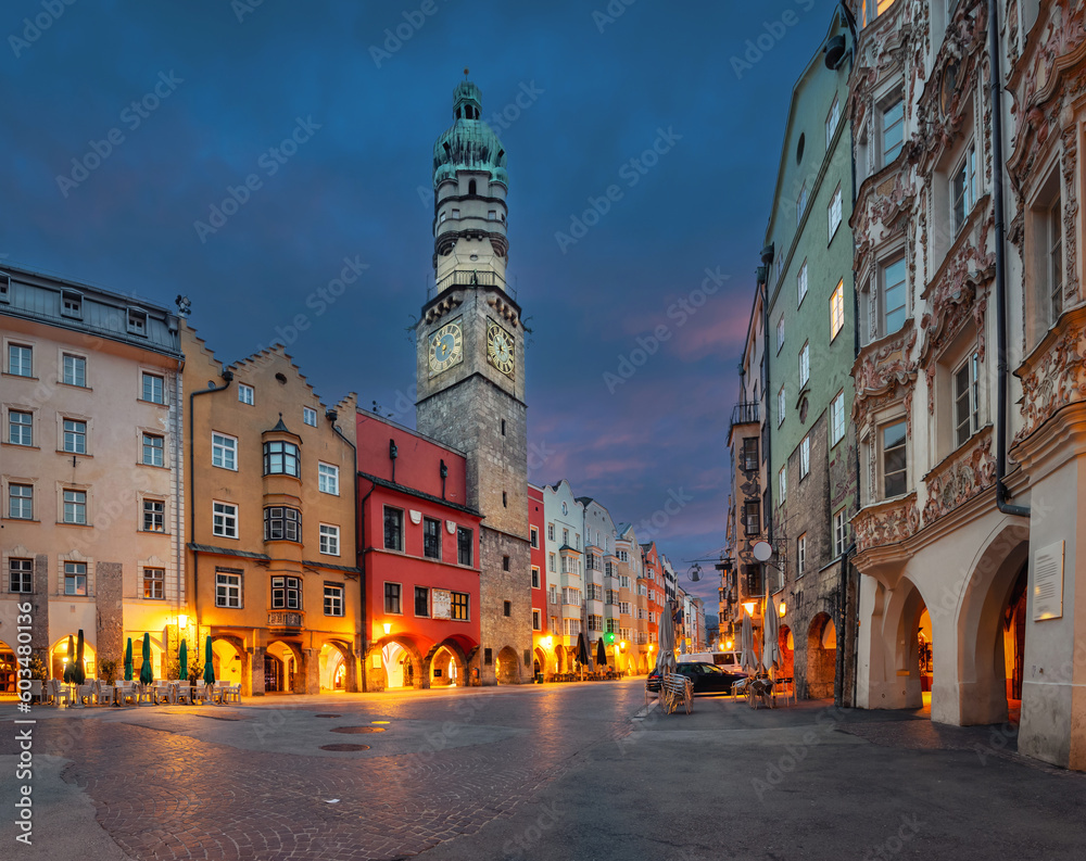 Innsbruck, Austria - view of historic Stadtturm tower with clock at dusk - obrazy, fototapety, plakaty 