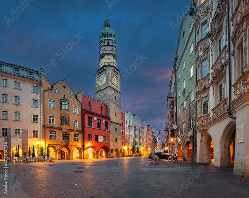 Innsbruck, Austria - view of historic Stadtturm tower with clock at dusk