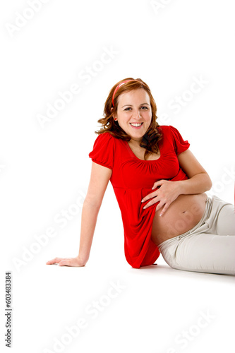 Beautiful pregnant woman on white enjoying this wonderful moment