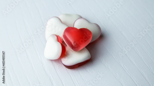 Heart shaped gummies on white background