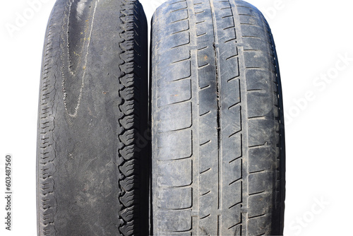 old worn out tire next to another old tire isolated on white background