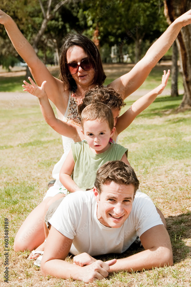 parents embracing and enjoying with two young children parents embracing and enjoying with two young children