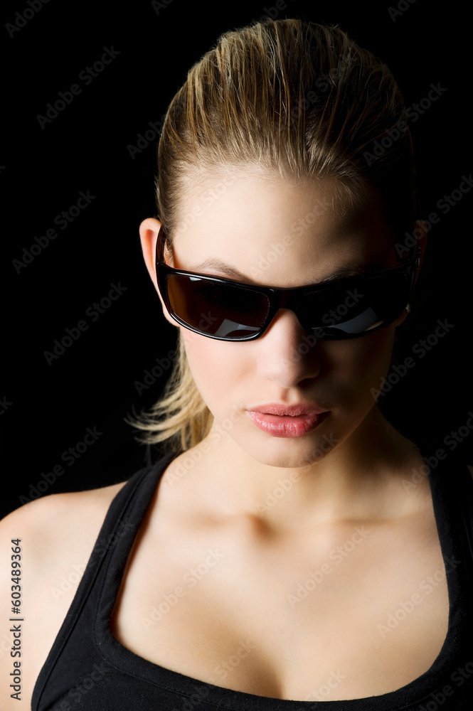 glamor portrait of a blond mistery woman with sunglasses looking down glamor portrait of a blond mistery woman with sunglasses looking down