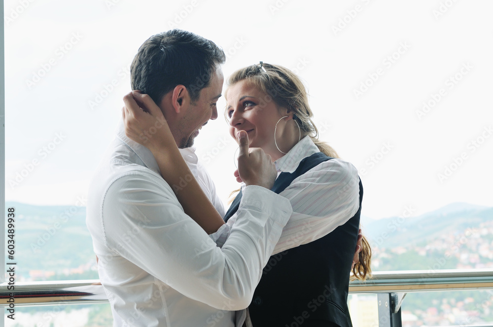 romantic happy couple relax and have fun at balcony in their new home apartment