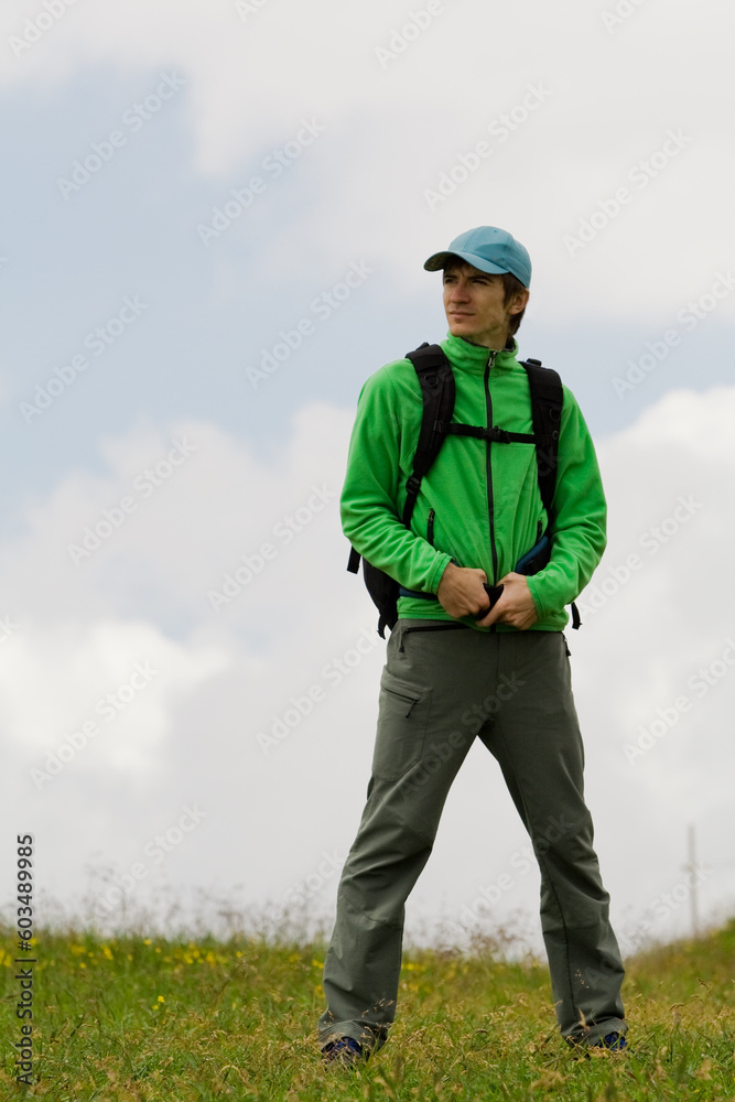 Young man on move, on the top of a mountain