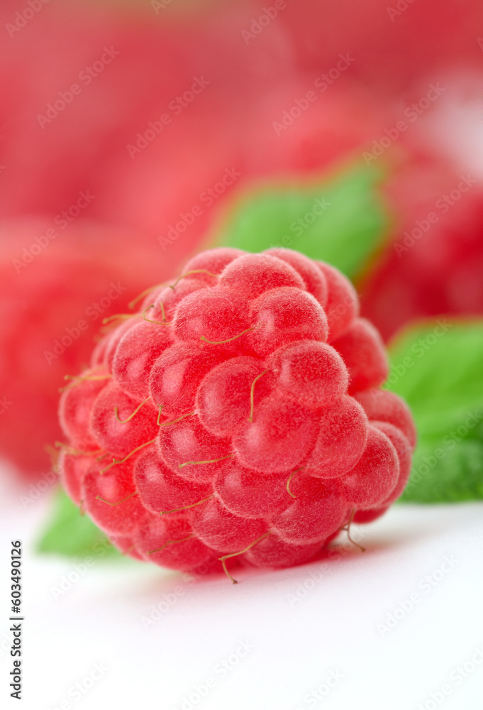 Raspberries with green leaves.This image is focused on one of them