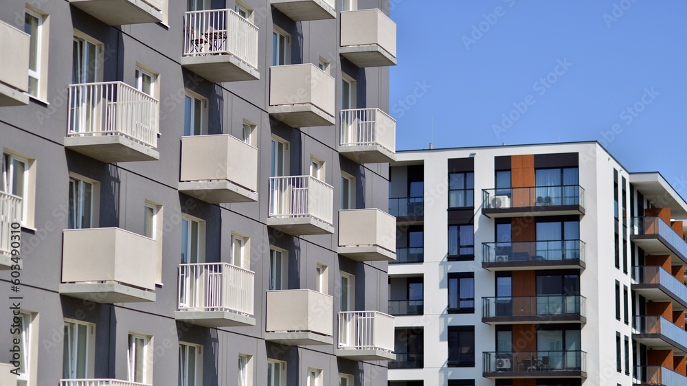 Apartment building with bright facades. Modern minimalist architecture with lots of square glass windows and balconies. Apartment building with bright facades. Modern minimalist architecture with lots of square glass windows and balconies.
