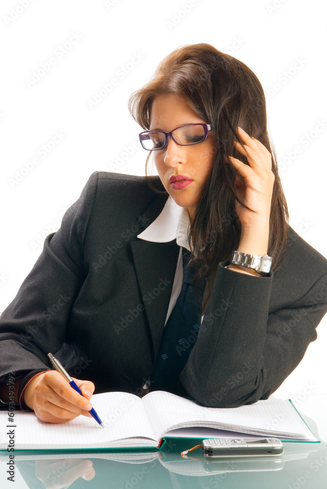 a young woman in black jacket and white shirt and a tie sitting down behind an office table and playing with glasses