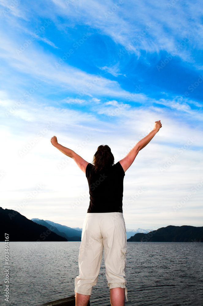 woman with her arms up over blue sky woman with her arms up over blue sky