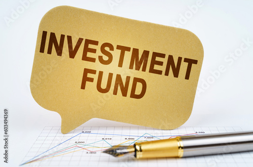 On the business diagram is a pen and a sign with the inscription - Investment Fund