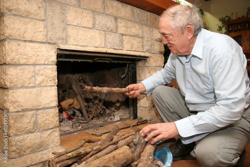old man beside fireplace in the house