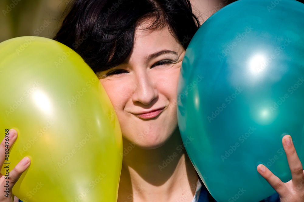 Cute girl between two colored balloons Cute girl between two colored balloons