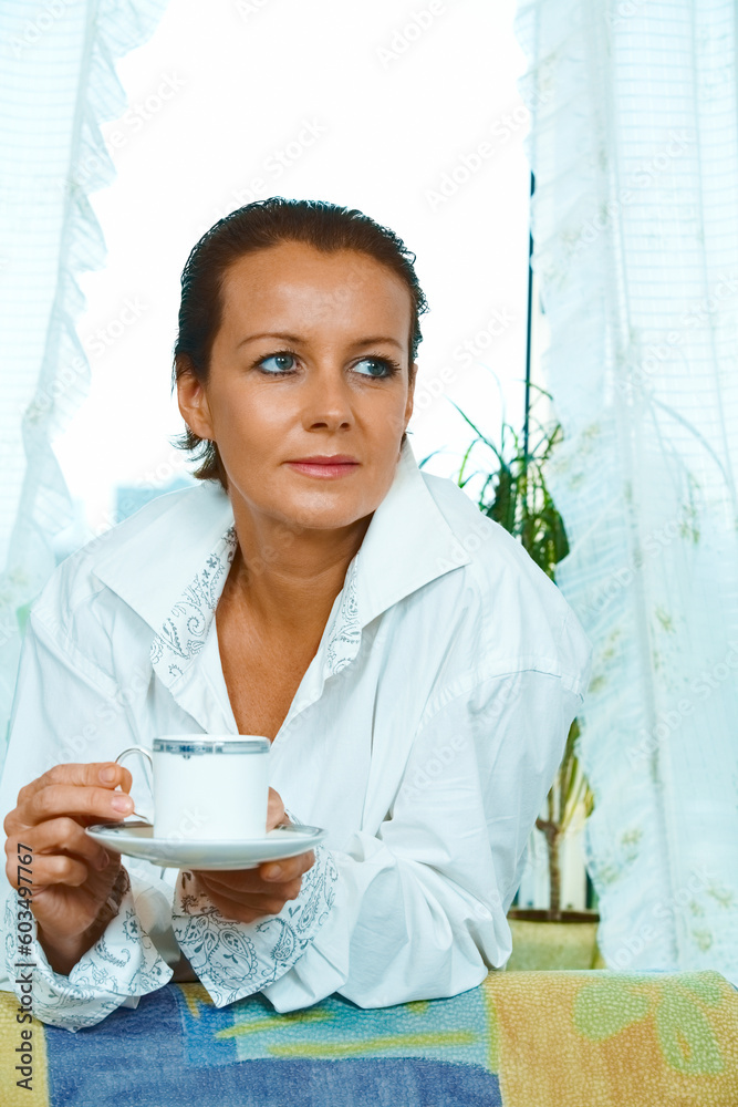 High key portrait of nice gorgeous woman drinking coffee High key portrait of nice gorgeous woman drinking coffee