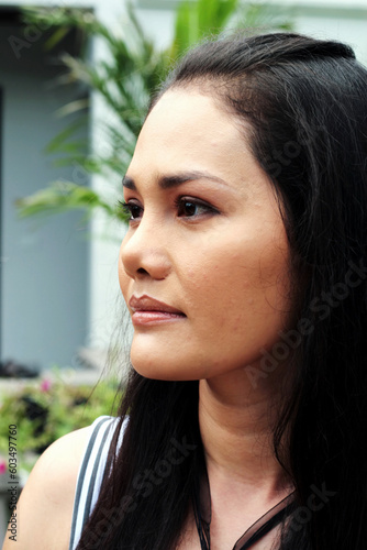 Close-up portrait of a happy Thai woman.
