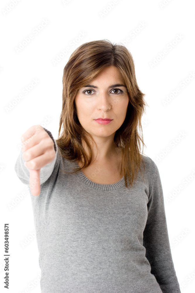 Portrait of an unhappy young woman with thumbs down. - Isolated on white Portrait of an unhappy young woman with thumbs down. - Isolated on white