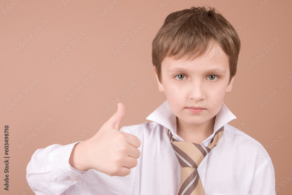 Young businessman giving a thumbs up isolated on beige Young businessman giving a thumbs up isolated on beige