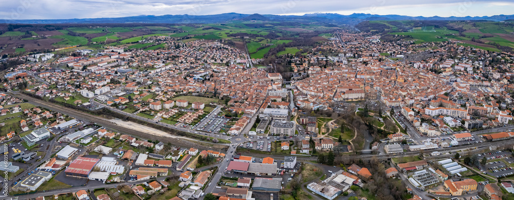 Aerial around the city  Issoire on a sunny day in early spring.