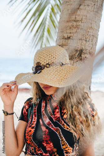 young girl with hat on the beach