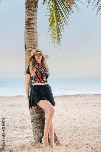 young girl with hat on the beach