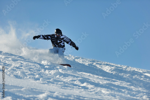 freestyle snowboarder jump and ride free style at sunny winter day on mountain