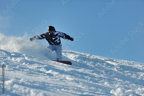 freestyle snowboarder jump and ride free style at sunny winter day on mountain