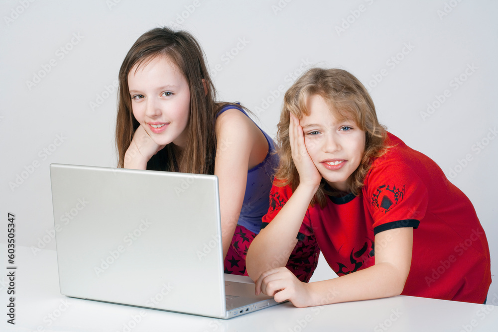 young boy and girl having fun with laptop computer