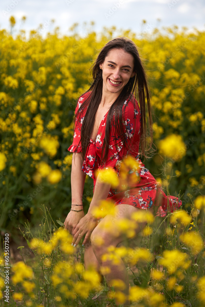 Beautiful latino woman in floral dress in a canola field Beautiful latino woman in floral dress in a canola field