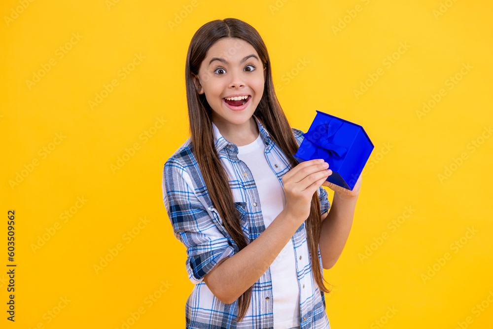 surprised birthday teen girl with birthday gift present box isolated on yellow surprised birthday teen girl with birthday gift present box isolated on yellow