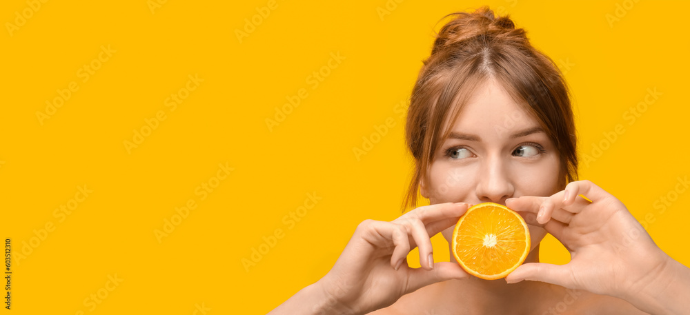 Beautiful young woman with orange on yellow background with space for text Beautiful young woman with orange on yellow background with space for text