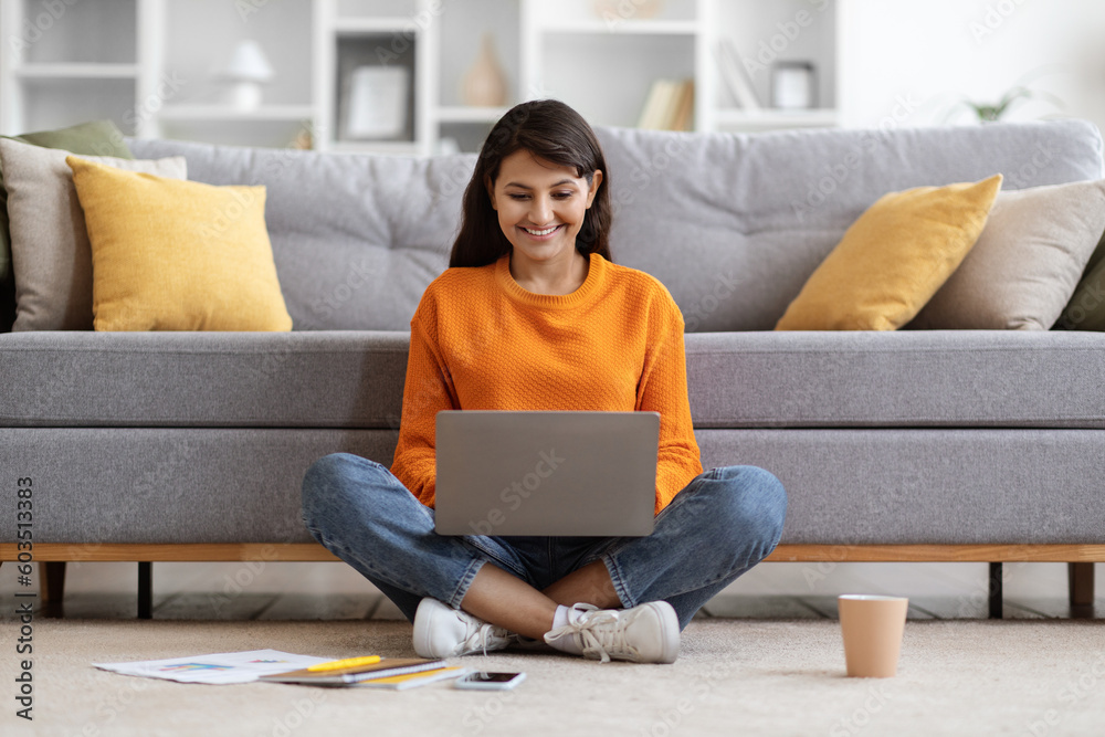 Smiling pretty lady working online from home, using laptop Smiling pretty lady working online from home, using laptop
