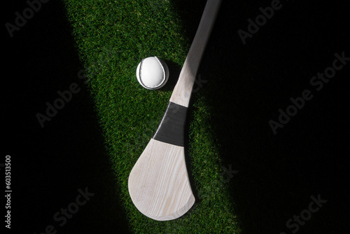 Hurling bat and sloitar on green grass. Horizontal sport theme poster, greeting cards, headers, website and app