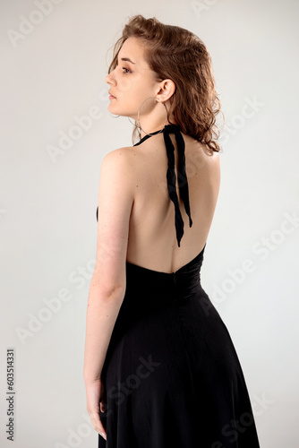 young girl in a black dress on a white background