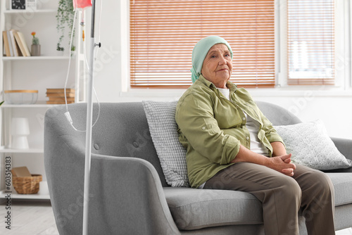 Senior woman after chemotherapy sitting on sofa at home © Pixel-Shot