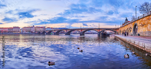Panorama of Palacky Bridge and evening Vltava with mallards, Prague, Czechia photo