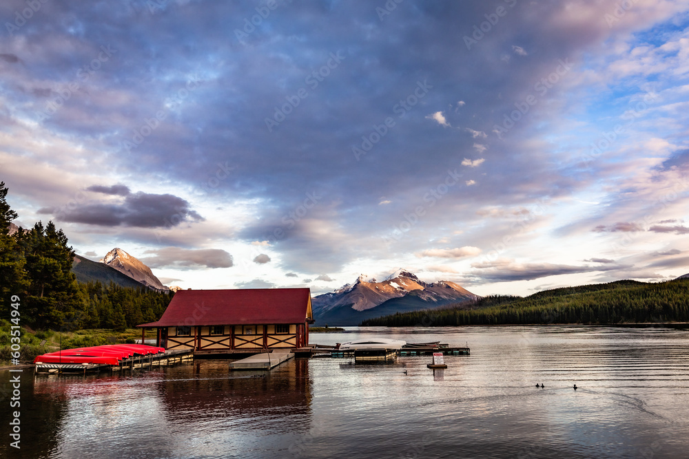 The sky painted with clouds clear from the wind, threatening among glimpses of blue, and below the lake with its flat, calm, tranquil surface. A cottage for renting canoes brings this side to life. A The sky painted with clouds clear from the wind, threatening among glimpses of blue, and below the lake with its flat, calm, tranquil surface. A cottage for renting canoes brings this side to life. A
