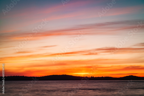 Sunset on the shores of Vancouver Island. Orange and dark tones of the landscape make this sunset timeless. Tofino  Vancouver Island  British Columbia State  Alberni - Clayoquot Regional District.