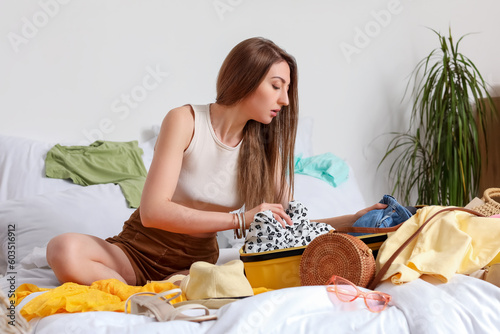 Young woman unpacking her s...