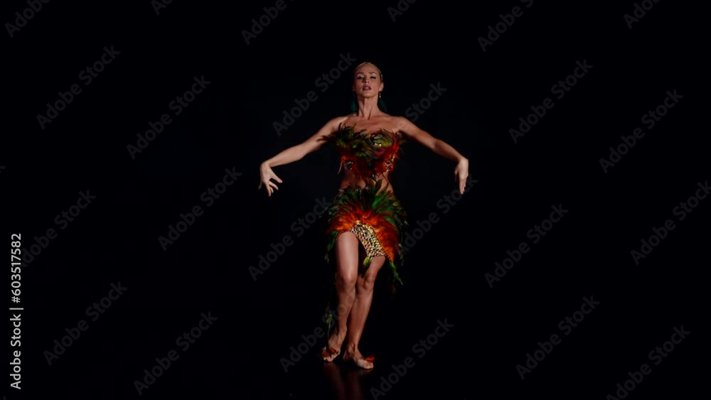 beautiful woman in scenic suit of paradise bird dancing on stage, exotic dance performance beautiful woman in scenic suit of paradise bird dancing on stage, exotic dance performance
