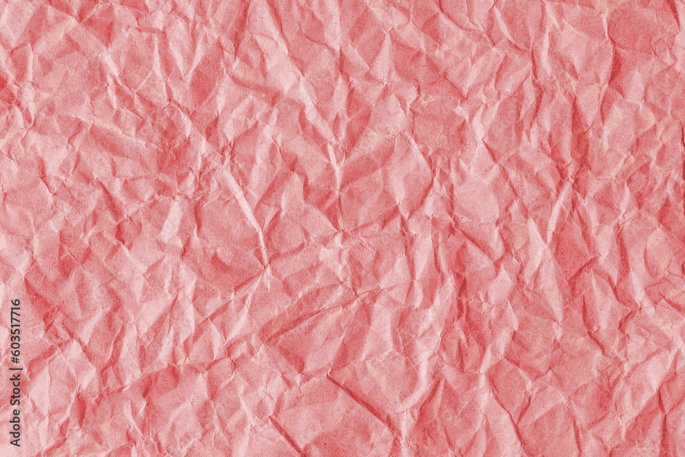Fototapeta premium Recycled crumpled red paper texture background. Wrinkled and creased abstract backdrop, wallpaper with copy space, top view.