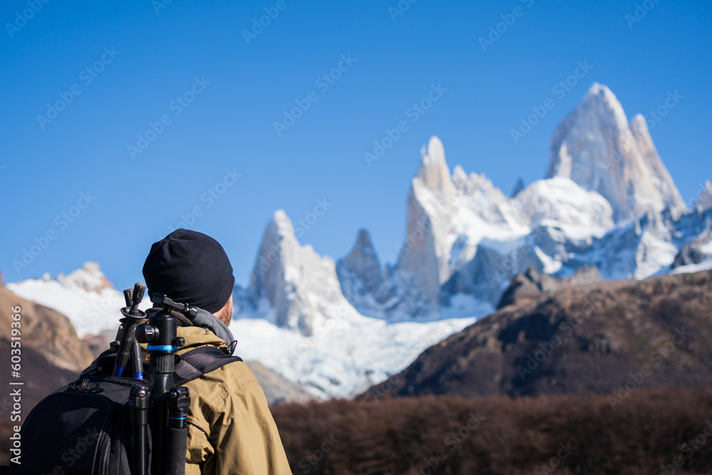 mountaineer photographer observing Mount Fitz Roy on a trail in El Chaltén, Patagonia Argentina. Photo from behind.