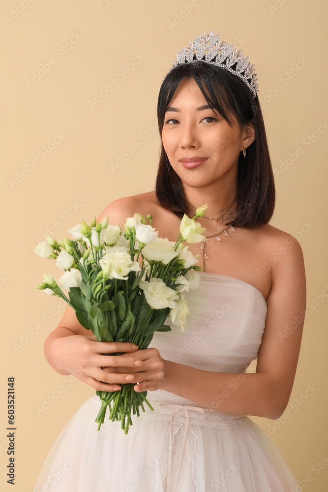 Beautiful young Asian bride with bouquet of eustoma flowers on beige background Beautiful young Asian bride with bouquet of eustoma flowers on beige background
