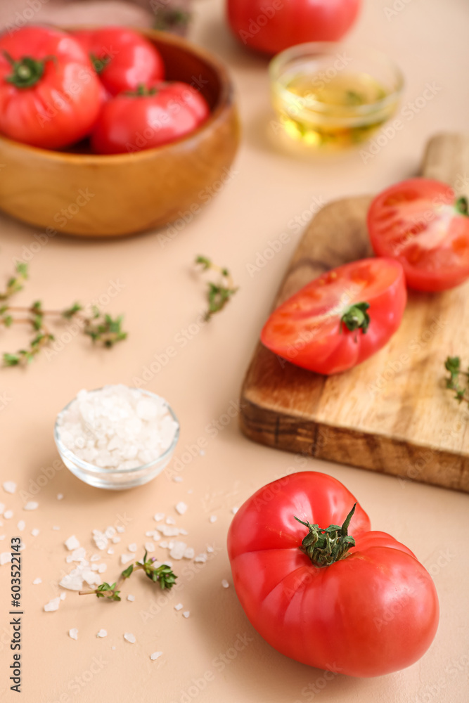 Bowl and board with fresh tomatoes on beige background Bowl and board with fresh tomatoes on beige background