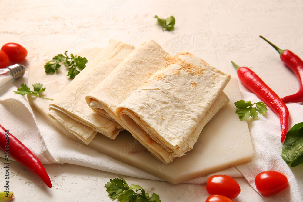 Board with fresh lavash on light background Board with fresh lavash on light background
