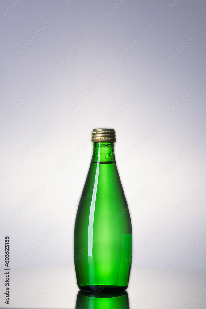 Green water bottle in close up with space for text Green water bottle in close up with space for text