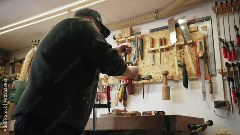 male carpenter using an old brace and creating a hole in a wooden plank, medium shot. High quality 4k footage male carpenter using an old brace and creating a hole in a wooden plank, medium shot. High quality 4k footage