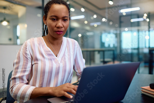 African American businesswoman using laptop while working in office. Free Download African American businesswoman using laptop while working in office. - GFXLoad