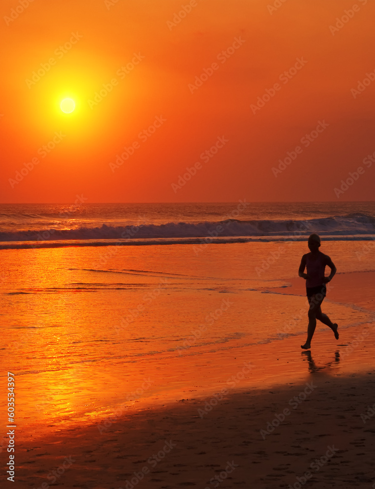 Man Running at sunset on the beach