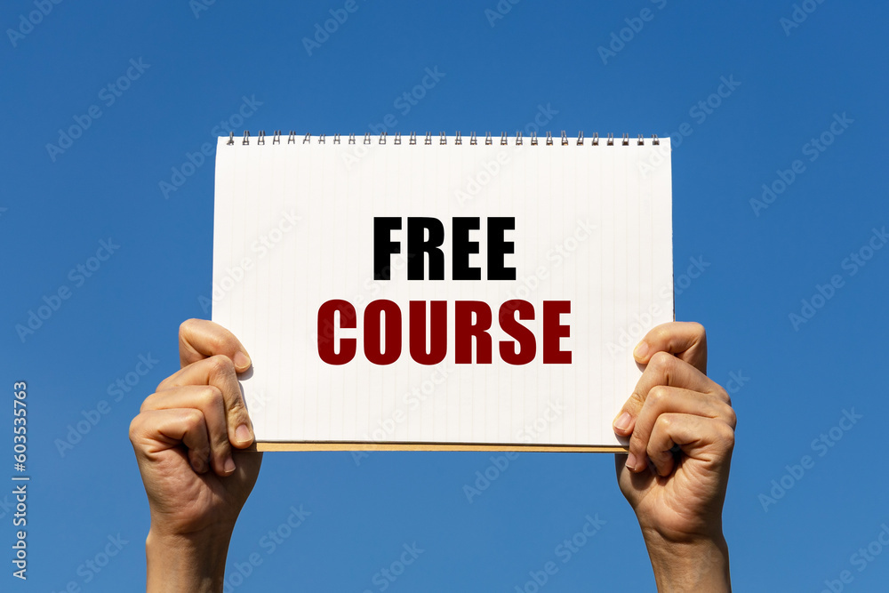 Free course text on notebook paper held by 2 hands with isolated blue sky background. This message can be used as business concept about free course. Free course text on notebook paper held by 2 hands with isolated blue sky background. This message can be used as business concept about free course.