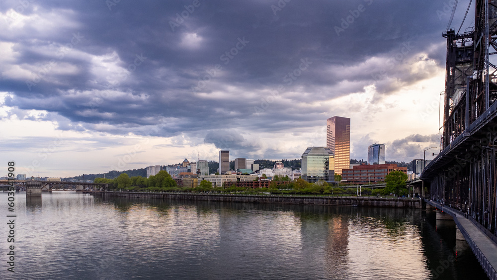 View of Portland, Oregon from the west showing sky, clouds, the Willamette River and a Bridge.