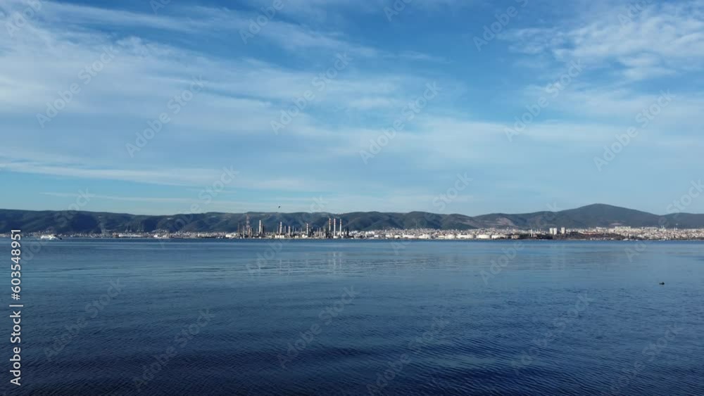 Aerial view of oil refinery plant. Drone view of an oil refinery plant across the sea. World environment day concept. Aerial view of oil refinery plant. Drone view of an oil refinery plant across the sea. World environment day concept.